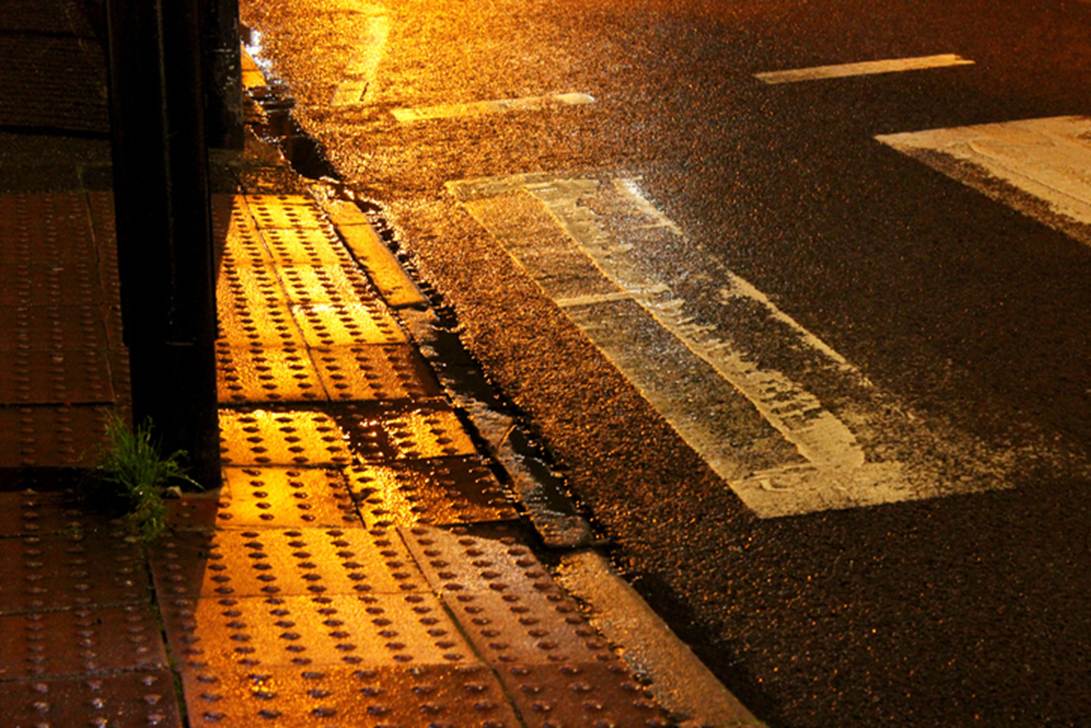 A wet street with a crosswalk
AI-generated content may be incorrect.